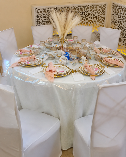 Festlich gedeckter Hochzeitstisch mit weißen Stühlen und Blumendekoration im Riad Mashallah Karben